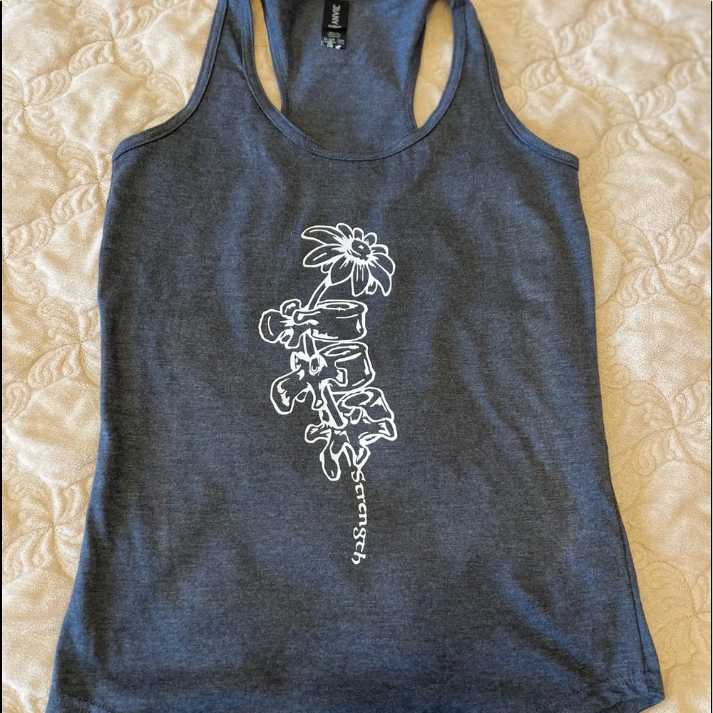 Flower/spine tank top with quote “strength”
